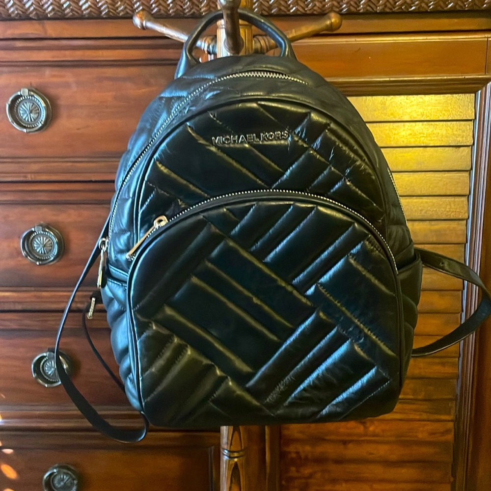 Michael Kors small black backpack w/silver  2 zip open and 1 slip back pocket